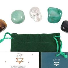 some rocks are sitting on top of a green bag and next to it is a card that says earth