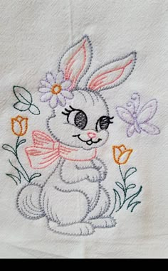 a white towel with an embroidered bunny on it