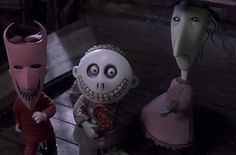 three creepy dolls standing next to each other