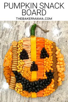 a pumpkin made out of fruits and vegetables on top of a marble surface with the word happy written in it