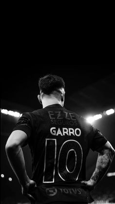 a man standing in the middle of a soccer field wearing a jersey that says garrio 10