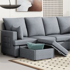 a living room scene with focus on the sectional sofa and footstool that is open