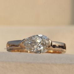 a ring with a pear shaped diamond on it