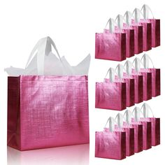 pink shopping bags with white handles are lined up against each other on a white background