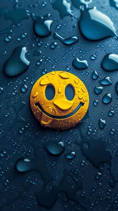 a yellow smiley face with water droplets on it