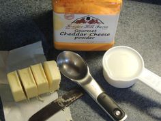 cheesecake ingredients including butter, butter knife and spoon