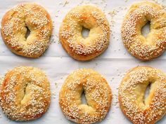 six bagels with sesame seeds on top