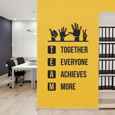 there is a sign that says together everyone achieve more on the wall in an office