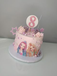 a pink and white birthday cake with two girls'faces on it, one has a number 8