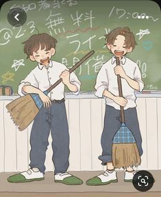 two young boys holding brooms in front of a chalkboard with writing on it