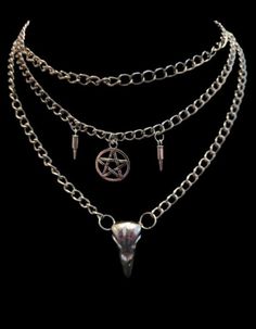 Looking for a bold and edgy accessory to complement your style? Look no further than my Layered Skull Necklace! This unique piece features a metal bird skull, complemented by faux bullets and a pentacle symbol, all suspended from layered chains.  The skull pendant is the focal point of this striking necklace, with intricate details that are sure to catch the eye. The faux bullets add an additional dimension of toughness and grittiness to this already rugged accessory. The pentacle symbol brings Edgy Halloween Streetwear Necklaces, Edgy Halloween Streetwear Necklace, Edgy Skull Chain Jewelry, Edgy Skull-shaped Chain Jewelry, Edgy Accessories, Gothic Skull, Bird Skull, Metal Birds, Layered Chains