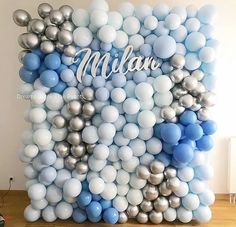 the balloon wall is decorated with blue, silver and white balloons that spell out the name mian