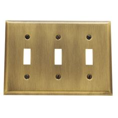 an antique brass finish toggle switchplate with three outlets and two plates on each side