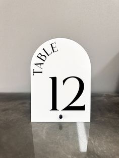 a white table number with black numbers on it