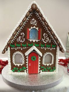 a gingerbread house is decorated with icing and decorations