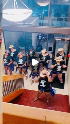 a group of women in cowboy hats are dancing