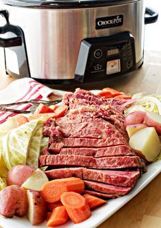 a plate with meat, potatoes and carrots next to an instant pot roaster