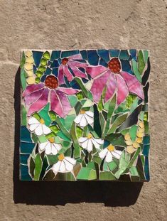 a mosaic with flowers and leaves on it