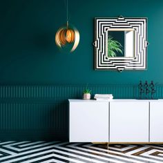 a room with green walls and black and white patterned flooring, a large mirror on the wall