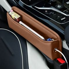 the interior of a car with an electronic device and charger in its pocket on the dashboard