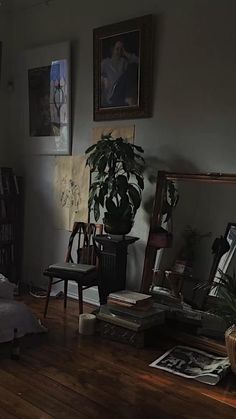 a bed sitting in a bedroom next to a tall wooden shelf with pictures on it