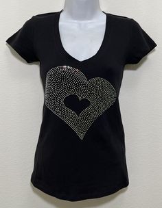 Fabric comprised of 95% cotton and 5% spandex.  Handmade rhinestone t-shirts made in the United States with quality rhinestones. Machine washable. T-shirt style is a fitted V-neck cap sleeve. AB stands for Aurora Borealis; this is the type of rhinestone used on our T-shirt creating a unique multi-dimensional shine. Size Range:         XXS = 2         XS = 4         S = 6         M = 8         L = 10         XL = 12 Embellished Cotton Short Sleeve T-shirt, Cotton Embellished Short Sleeve T-shirt, Fitted Black T-shirt With Rhinestones, Rhinestone Cotton Tops With Short Sleeves, Cotton Rhinestone Short Sleeve Top, Cotton Tops With Rhinestones And Short Sleeves, Cotton Short Sleeve Top With Rhinestones, Fitted Rhinestone Crew Neck T-shirt, Rhinestone Cotton Crew Neck T-shirt