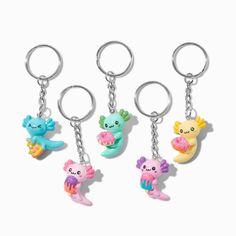 four key chains with cartoon characters hanging from it's ends and one is holding an object in the other hand