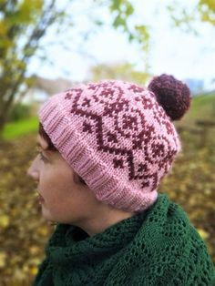 a woman wearing a pink knitted hat and scarf