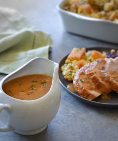 a bowl of soup next to a plate of food