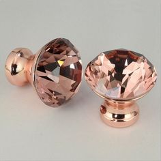 an image of two knobs that are in the shape of a rose gold diamond