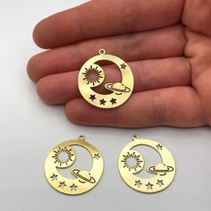 2pcs Raw Brass Round Saturn Planet Moon Sun Stars Charm Pendant, Saturn Planet Sunburst Crescent Moon Earring Charm Jewelry Supplies RW-1146 Material; Brass Size: 25x27.50mm Hole Size: 1.65mm Plating: Raw Quantity: Optional All of our products are designed and manufactured by us. If you want to order more products in stock, you can freely contact us. Our Products; -Nickel-free -Lead-free -High quality If you have any questions, feel free to contact us. You can read the explanations and policies Cat Necklace Gold, Moon Earring, Saturn Planet, Earring Charm, Laser Cut Wood Earrings, Black Gold Jewelry, Laser Cut Jewelry, Crescent Moon Earrings, Indian Jewelry Sets