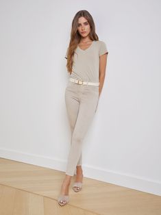 Our signature high-rise skinny jean crafted from premium, luxurious stretch denim in an oatmeal beige. Tapered leg hugs from hip to ankle, while the contoured waistband defines and slims the natural waist. High-recovery fabric holds its shape, smoothing the silhouette without sacrificing comfort. | L'AGENCE Margot Skinny Jean In Biscuit Staff Photos, Office Aesthetic, Teacher Outfit, Event Outfit, Gameday Outfit, Classic Fashion, Denim Coat, Medium Hair, Bottom Clothes