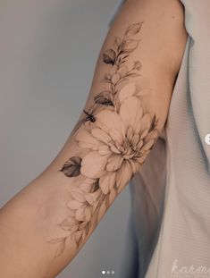 a woman's arm with flowers on it