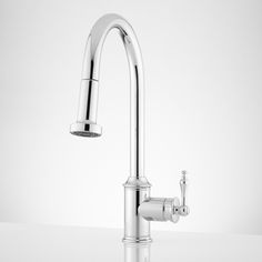 a chrome faucet on a white counter top with water running from the faucet