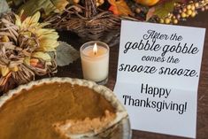 a table topped with a pie next to a candle and a sign that says, when the gobble gabble comes the snooze smore happy thanksgiving