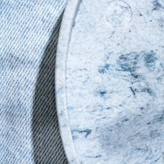 a close up of a marble table with a blue shirt on it's lapel