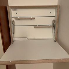 an open drawer on the side of a wall