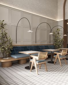 an empty restaurant with blue booths and wooden tables in front of white wall paneling