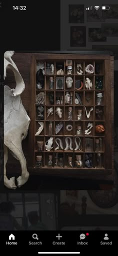 a wooden box filled with lots of different types of jewelry on top of a table