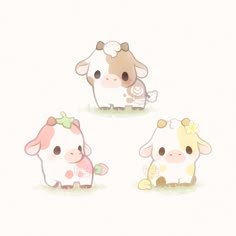 three little cows are standing in the grass