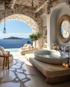 a bathroom with a large jacuzzi tub next to the ocean