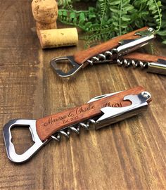 two bottle openers with corkscrew handles are sitting on a table next to some wine corks