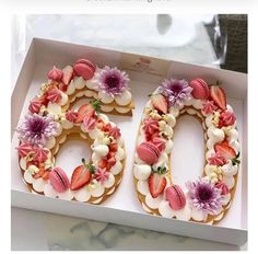 the number 50 is made out of cookies and decorated with strawberries, flowers and leaves