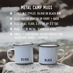 two coffee mugs sitting on top of a rock next to a river with the words metal camp mugs