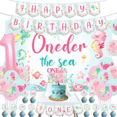 an under the sea 1st birthday party with balloons, cake and cupcakes for one year old