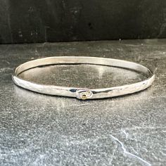 Get ready to rock the beach with this 4mm Sterling Silver Bangle! It's hammered for extra style and the sleek oval shape fits perfectly on your wrist. A 14k Yellow Gold Hook slide clasp adds a touch of luxury. Handmade to order, so make sure to measure your wrist accurately with a fabric tape measurer or string. Our rule of thumb: add 1/2" to a tight measurement for the best fit. And don't worry, we'll have your order ready in just 2-5 business days! Sterling Silver Bangle, Fabric Tape, Sterling Silver Bangles, Silver Bangle, Hammered Silver, Silver Bangles, Tape Measure, Oval Shape, Don't Worry