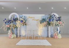 a decorated stage set up with flowers and chairs for a happy marriage ceremony at the reception venue