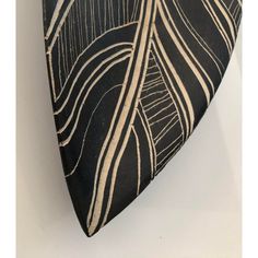 a black and white neck tie with leaves on it