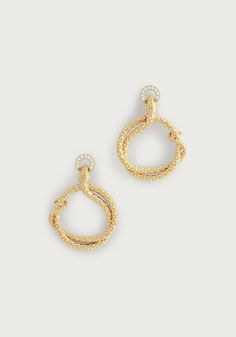 Elevate your style with the luxurious Serpent Holding Ring Hoop Earrings. Crafted from 18K gold dipped brass and adorned with sparkling handset pavé crystals, these earrings exude sophistication and opulence. Indulge in elegance with these stunning earrings. Made from 18K gold dipped brass and encrusted with dazzling handset pavé crystals, these hoops exude luxury and glamour. 18K gold plated brass Crystals 2" L X 1.4" W Luxury Gold Hoop Earrings With Pave Setting, Gold-tone Hoop Earrings For Evening, Elegant Gold Hoop Earrings With Pave Setting, Gold Diamond Hoop Earrings For Evening, Gold Diamond Earrings With Pave Setting For Evening, Glamorous Yellow Gold Hoop Earrings For Formal Occasions, Glamorous Yellow Gold Hoop Earrings For Formal Events, Luxury Gold-plated Hoop Earrings With Diamond Accents, Luxury Gold Plated Hoop Earrings With Diamond Accents