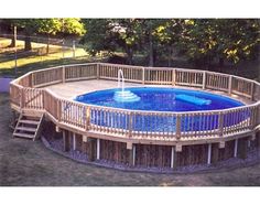 an above ground pool surrounded by wooden decking